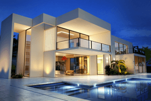 alt="Florida luxury home with a modern design and a sparkling pool with beautiful landscape lighting."
